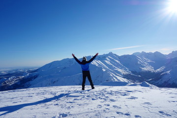 Young happy man at the top of Kopa Kondracka during winter, Zakopane, Tatry mountains, Poland