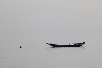 Silhouette of the long tail boat in the sea