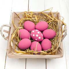 Pink Easter eggs on wodden background. Still life photo of lots of pink easter eggs. Copyspace.