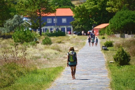 Young girl pilgrims arriving at Fisterra, Way of St. James, Finisterre, La Coru&ntilde;a, Galicia, Spain