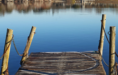 Fototapeta na wymiar Blue lake in the park with jetty