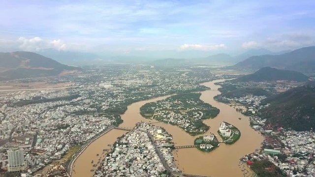 Large City Located on River Banks against Hills