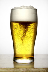 Glass of beer with white foam