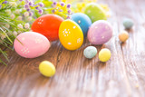 Easter eggs and spring flowers on rustic wooden background
