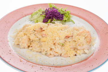 mediterranean food, dish of seafood stew covered with parmesan cheese