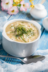Tasty mushroom soup with noodles on a wooden table.