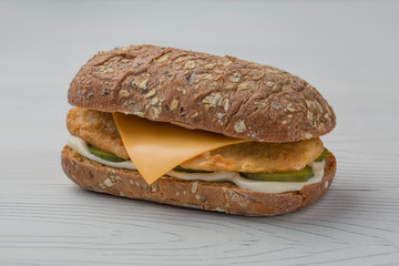 hamburger with fish, pickled cucumber and cheese on white backgroud