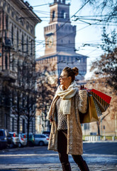 trendy traveller woman in Milan, Italy looking into distance