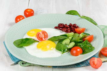 Breakfast of two eggs and vegetables