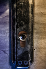 eye behind  keyhole 