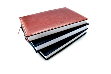 three notebook of brown and dark blue color isolated on white background