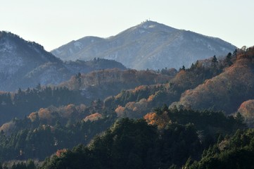 Fototapeta na wymiar 雪の大山と紅葉の山並み