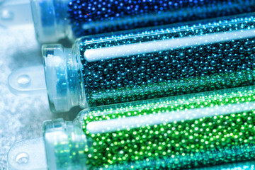 Green beads for nail design close-up