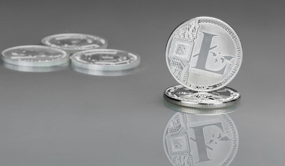 Modern digital silver coin Lightcoin on a gray background