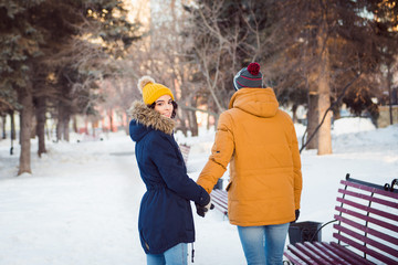 young couple walking winter park