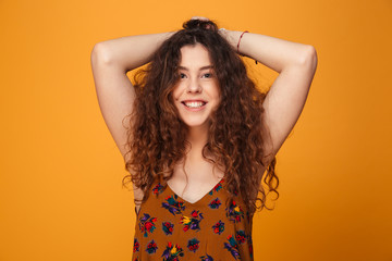 Fototapeta premium Cute young lady standing isolated over yellow background