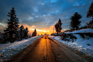 Beautiful sunset on a mountain and road in winter in HDR