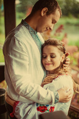 Fototapeta premium Woman leans to her man tender standing on the wooden footsteps