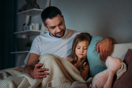 portrait of father looking at innocent sleeping daughter - Powered by Adobe