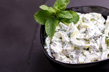 Indian cucumber raita with yoghurt, mint, cilantro. Greek tzatziki sauce