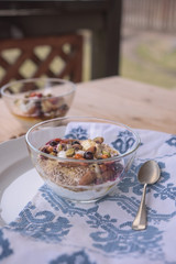Glass bowl with healthy snack and spoon next to each other