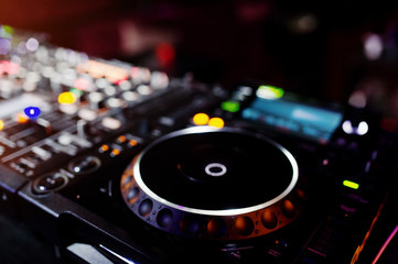 Fototapeta na wymiar DJ spinning mixing and scratching track controls on dj's deck strobe. Dj Music club life concept.