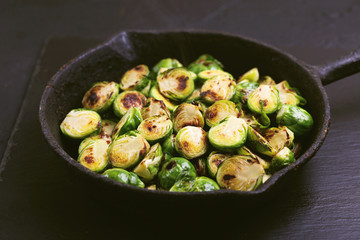 Vegetarian cuisine. Brussels Sprouts roasted with olive oil. Copyspace