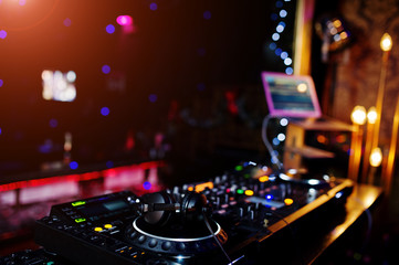 Fototapeta na wymiar DJ spinning mixing and scratching track controls on dj's deck strobe. Dj Music club life concept.