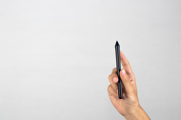 Hand holding a graphic tablet stylus, isolated with clipping path on white background