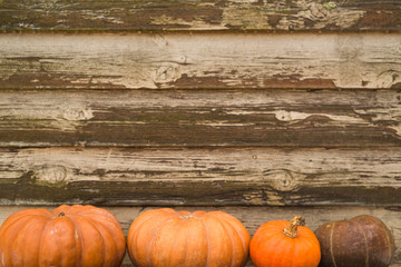 Orange autumn pumpkins on the old rustic table with vintage film colours background