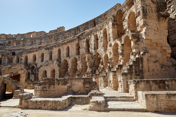 The impressive ruins of the largest colosseum in North Africa, a huge Roman amphitheater in the small village of El Jem, Tunisia.