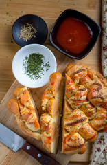 Sausage bread with dipping sauce and seasoning