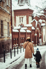 Fototapeta premium The mother with son walking along street