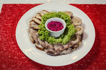 Food tray with delicious rolls, boiled pork served with marinated horseradish called as meat platter