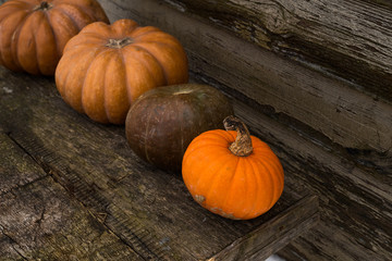 Orange autumn pumpkins on the old rustic table with vintage film colours background