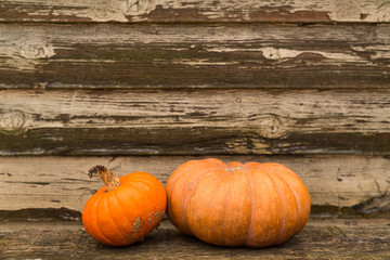 Orange autumn pumpkins on the old rustic table with vintage film colours background