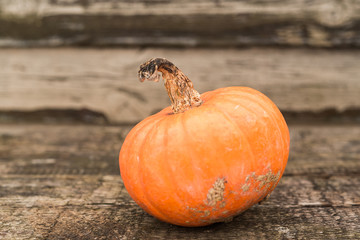 Orange autumn pumpkins on the old rustic table with vintage film colours background