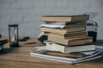 close-up shot of stacked books on work desk