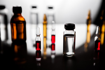 Group of ampoules with a transparent medicine in medical laboratory