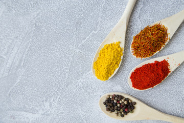 Set of spices and herbs on light stone background