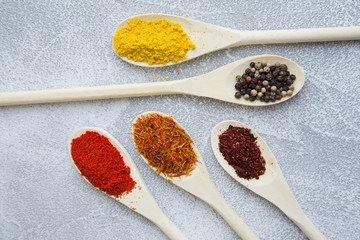 Set of spices and herbs on light stone background