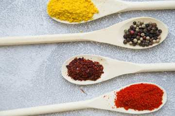Set of spices and herbs on light stone background