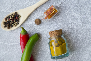 Set of spices and herbs on light stone background