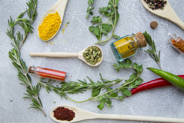 Set of spices and herbs on light stone background