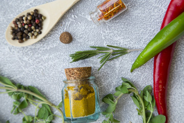 Set of spices and herbs on light stone background