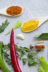Set of spices and herbs on light stone background