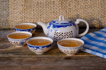 porcelain teapot and bowls with green tea