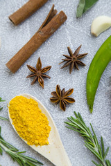 Set of spices and herbs on light stone background