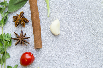 Set of spices and herbs on light stone background