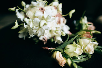 A beautiful wedding bouquet of brides from white flowers on a dark wooden background
